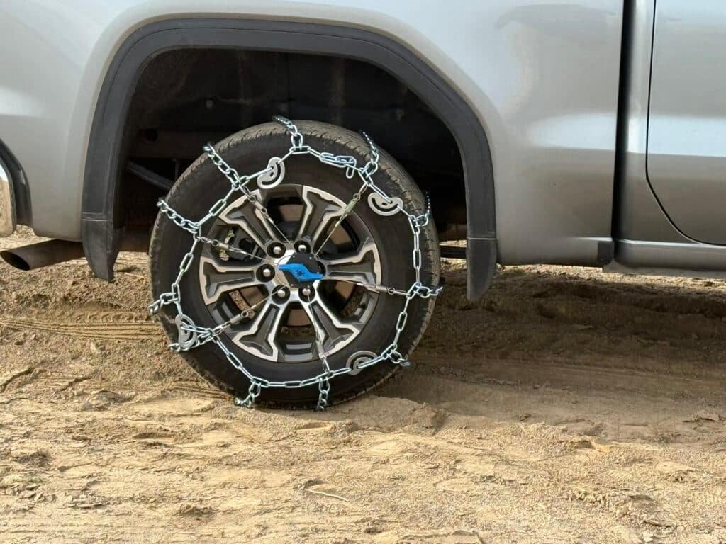 The Kranken tensioner installed on a truck tire in the snow