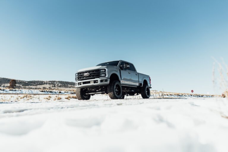 Pickup truck chained up on an open snowy backcountry road