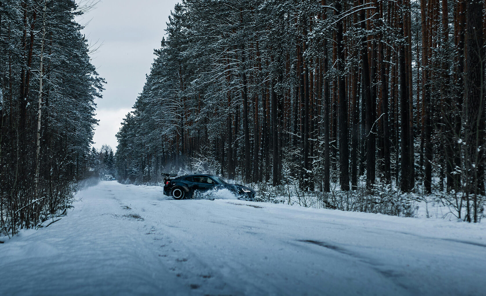car skidding on a forest road in the winter